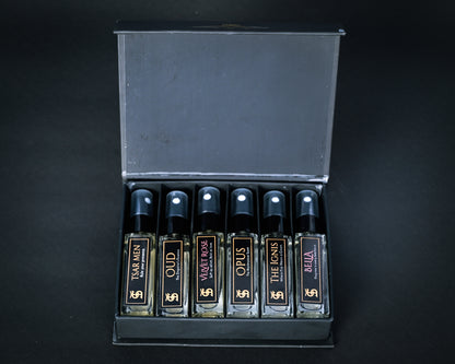 Set of perfume bottles in a display case on a black background
