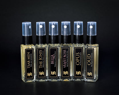 Set of perfume bottles with black and gold labels on a dark background